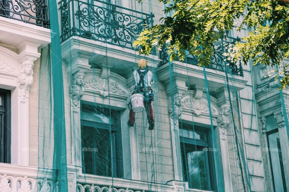 Man working on a house facade 