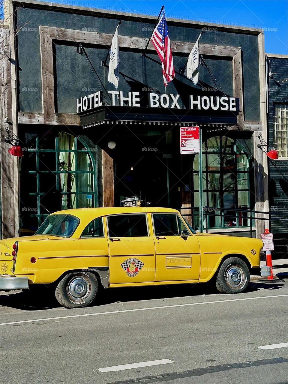 This is “THE BOX HOUSE HOTEL” on “Box Street” right by the “Pulaski Bridge” and “Newtown Creek” in “Greenpoint”, Bklyn. The elegant lobby with a lettered awning and flags always has at least one yellow cab parked outside. 2024. Hypnotic Productions