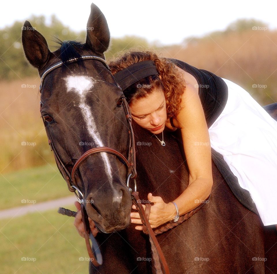 For the love of a horse . A beautiful black horse getting a hug from gs rider
