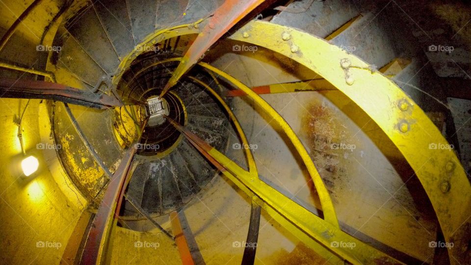 Bunker spiral stairs. Yellow  spiral Stairs inside a bunker, diamond head Honolulu Hawaii 