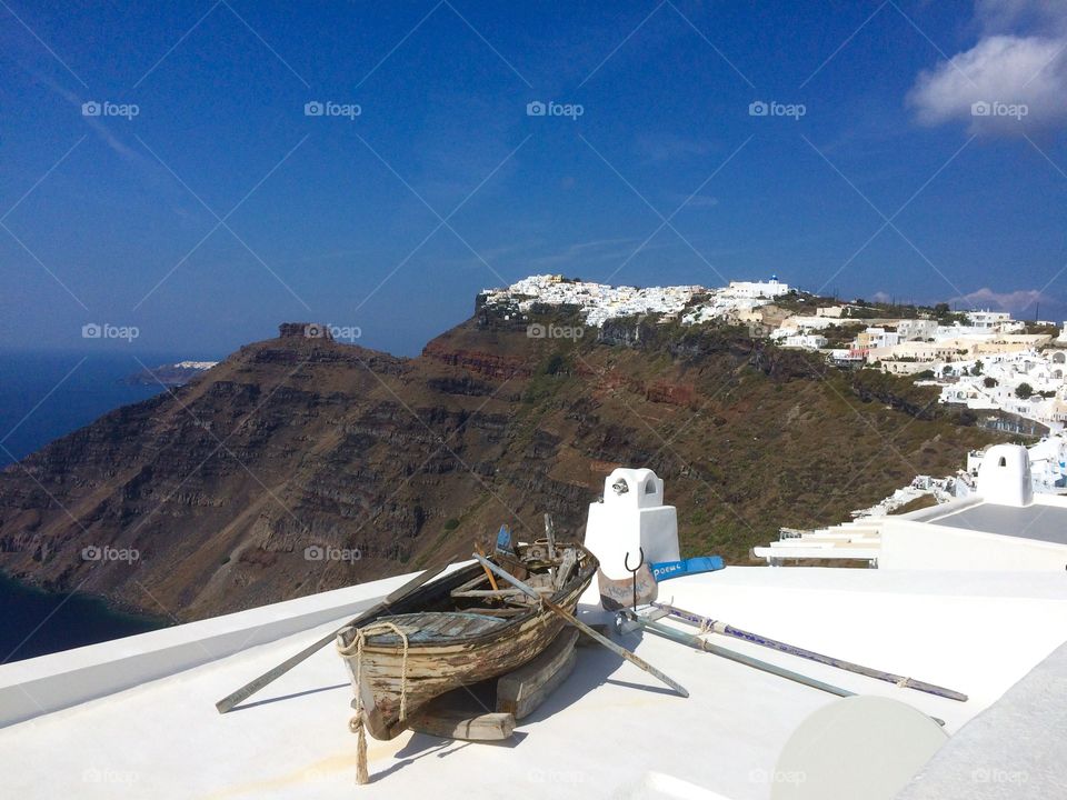 Oia town and abandoned boat in Santorini, Greece