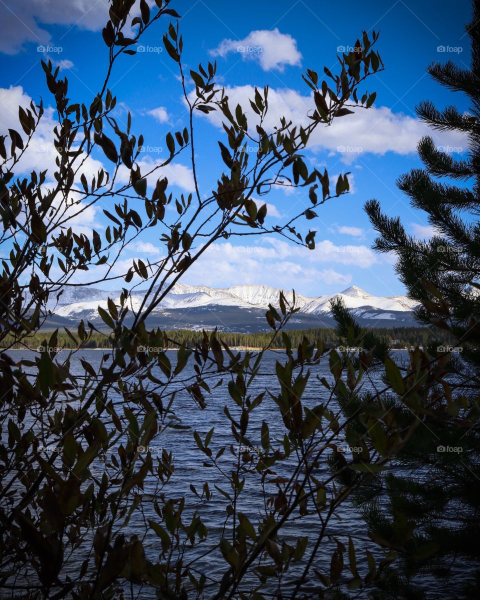 On the lakeshore with the view of the mountains across it.
