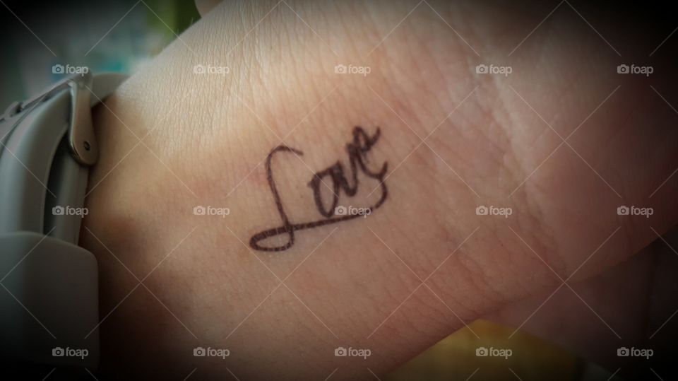love tatoo in hand