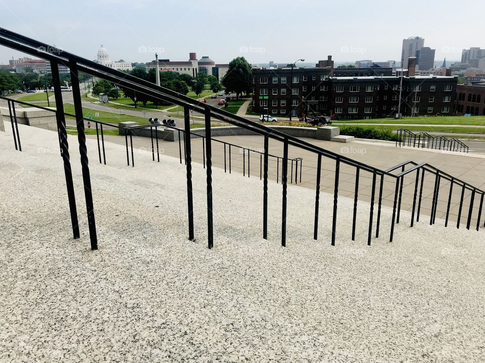 Fun rectangular shaped black railing on steps leading up to catholic cathedral! 