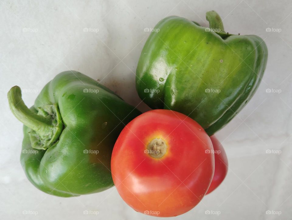 Red tomato and green chilli, both are contrace opposite colour, vegetable beautiful seasonal nature generally found everywhere