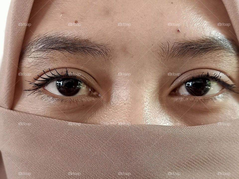 Portrait of woman covering part of her face