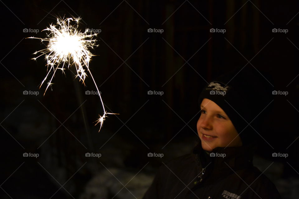 Boy eating ice-cream while sitting on sofa