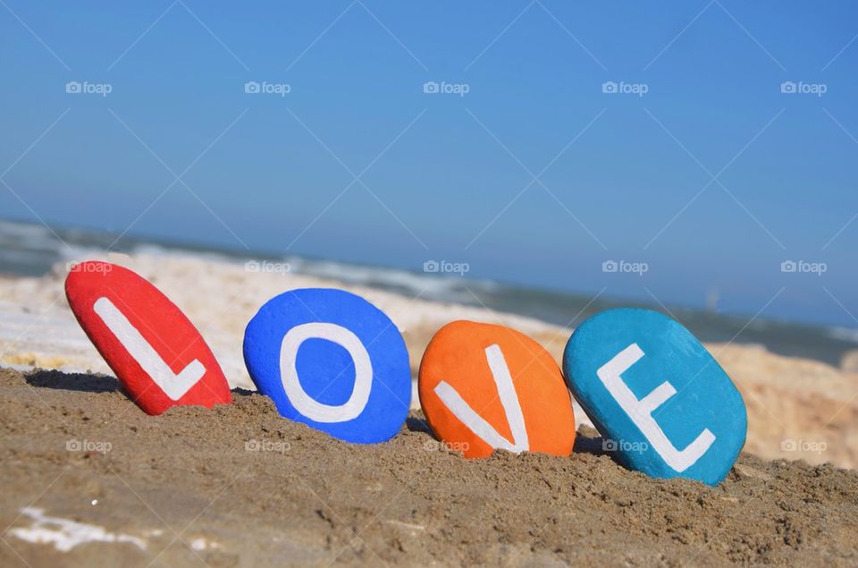 Love written on the sloping stones over the sand