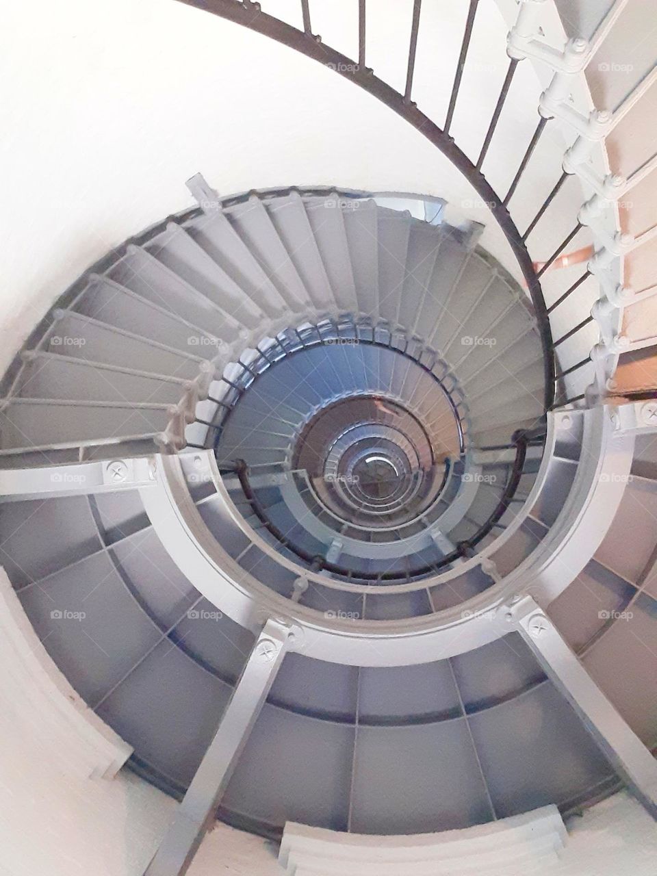 A photo taken from the ground up of the steep spiral staircase of the Ponce Inlet Lighthouse.