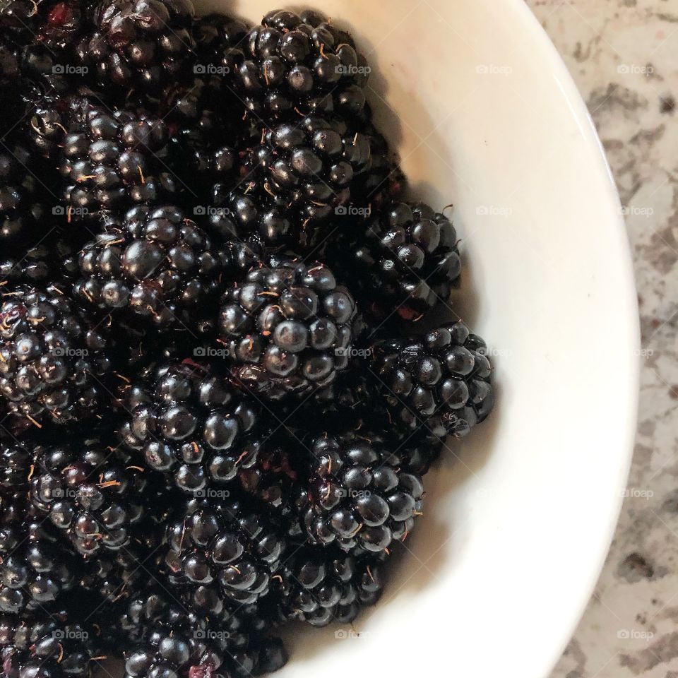 Eating healthy with a bowl of blackberries
