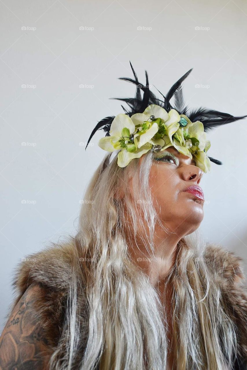 Forest Nymph woman wearing theatrical outfit wreath and furniture art creative portrait