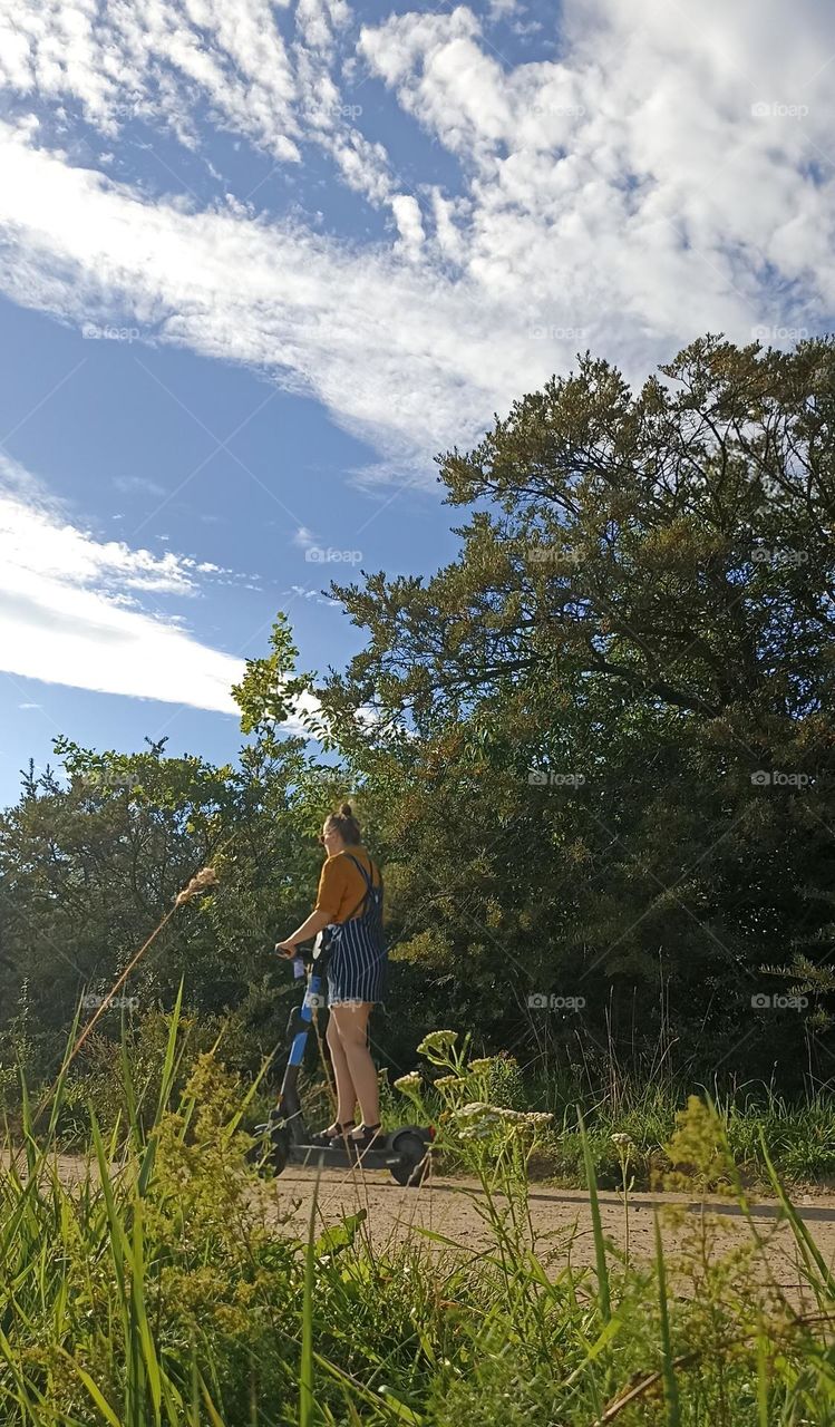 girl on a electric scooter, summer time