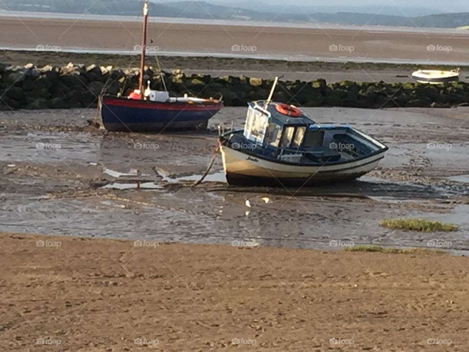 John Smalley. . Boats mored on morcambe sea front  waiting for the tide to come in 