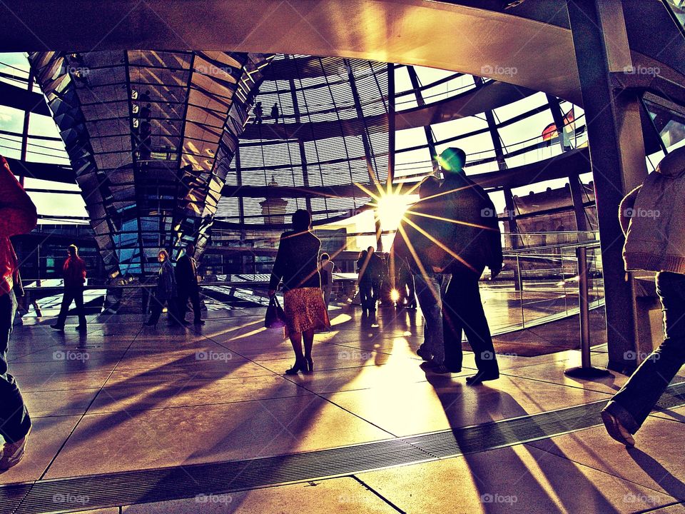 under the dome. visitors of reichstag in the sun