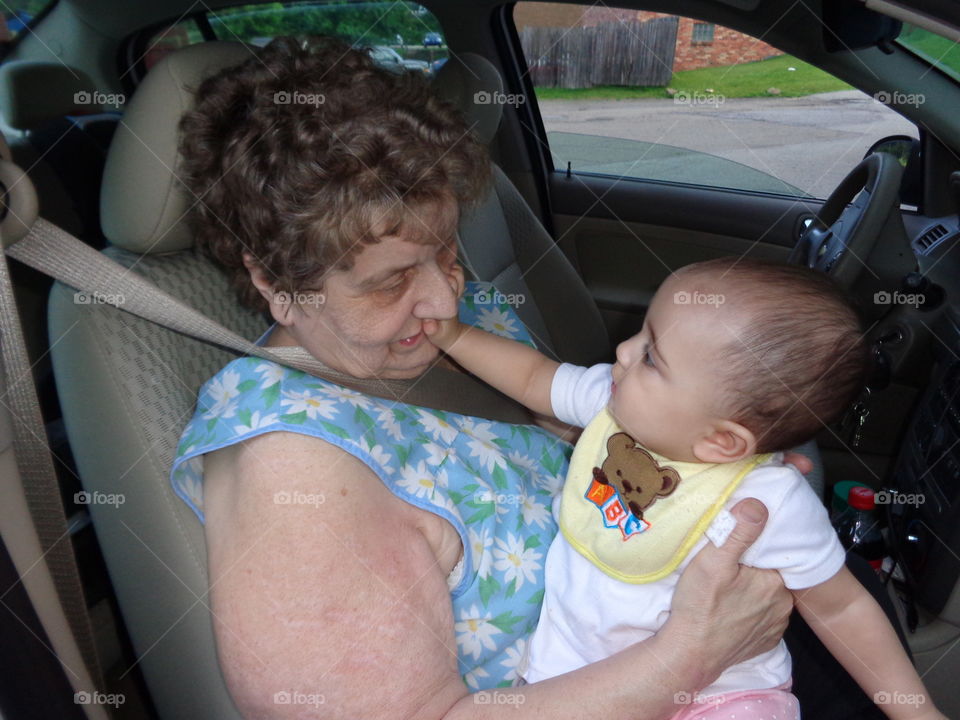 baby touch grandma on face