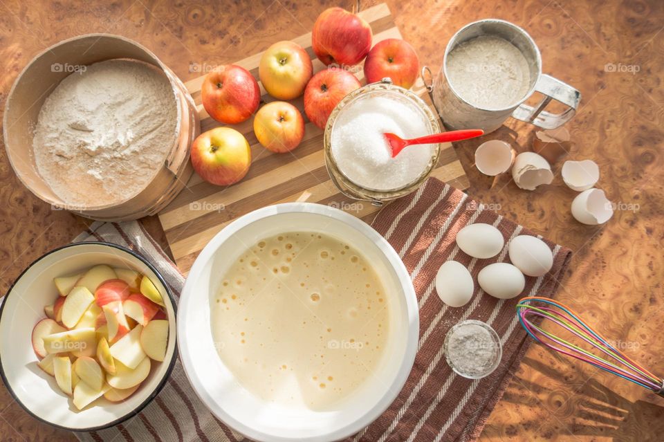 Making homemade puffed apple pie with eggs, sugar and flour.