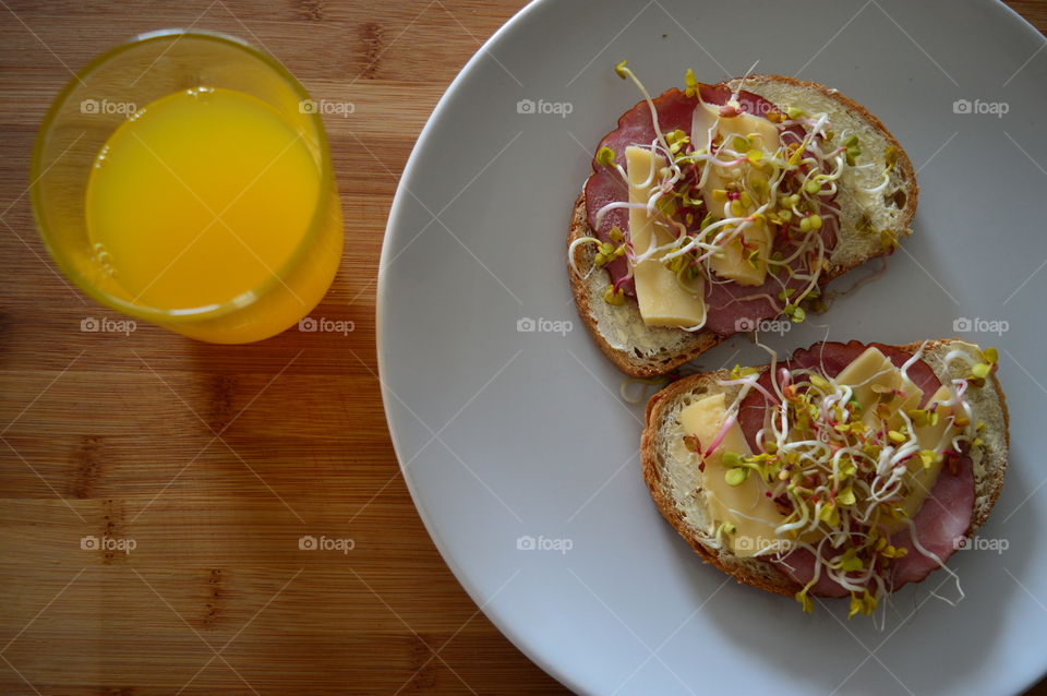 Meat sandwich and juice for breakfast