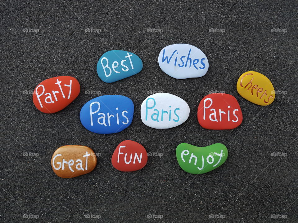 Paris, souvenir with many colored stones over black volcanic sand