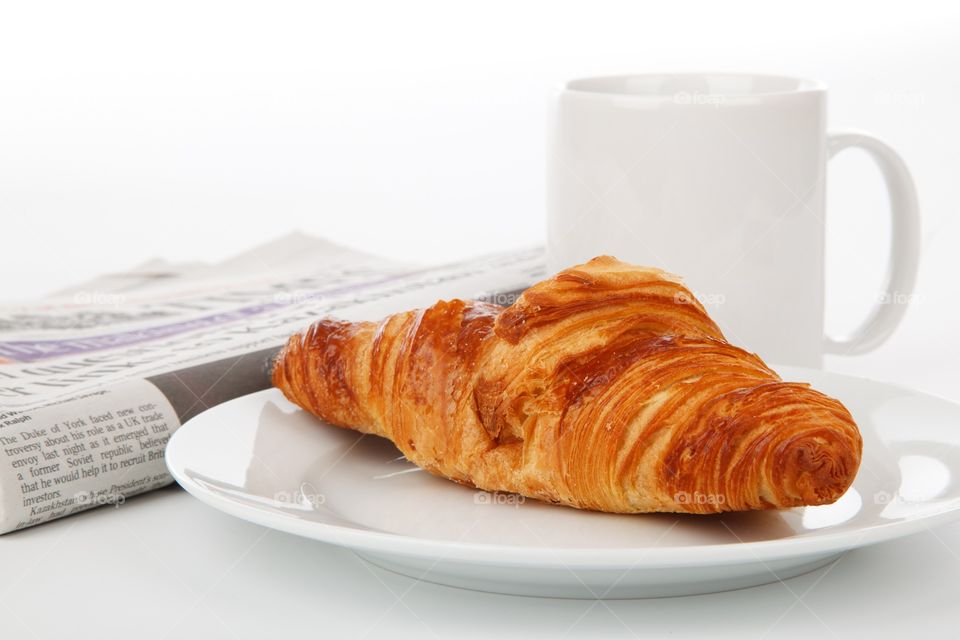 Croissant and tea for you to read your morning newspaper