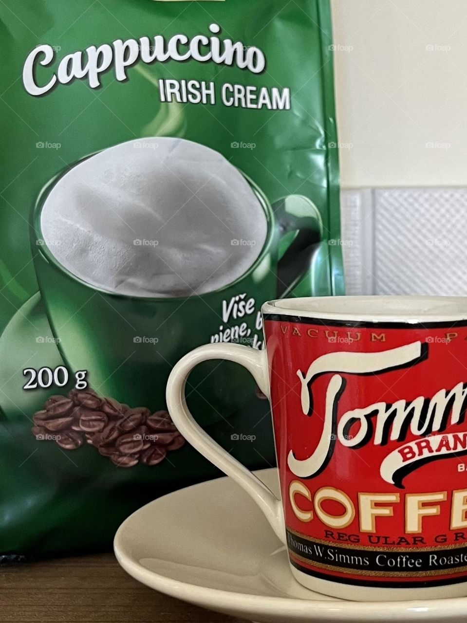 Complementary colors of red and green with a green bag of coffee and red coffee cup.