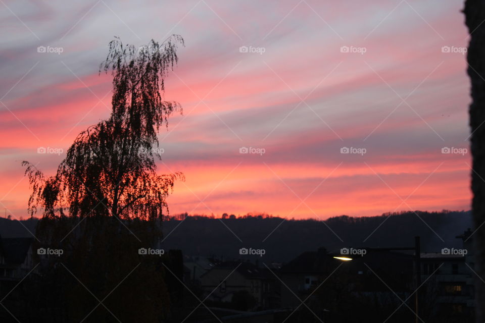 Look outside to see the beautiful weather and sun shining on earth. To your surprise you a beautiful sunset, with various colors,pink,purple,and orange and more.