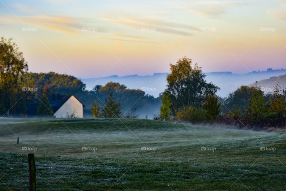 Scenic view of landscape at foggy morning