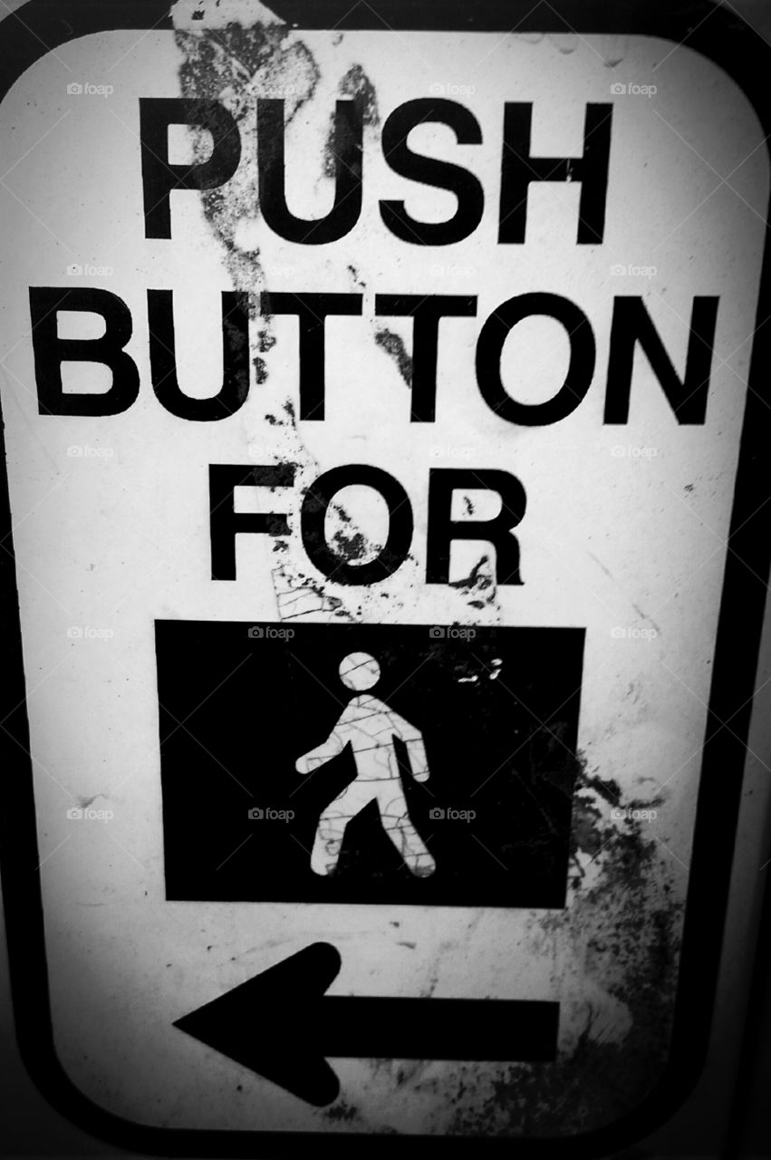 Push button to walk sign at an intersection.