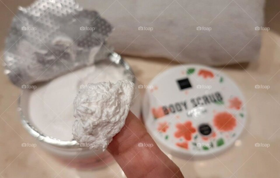Someone takes body scrub using his finger