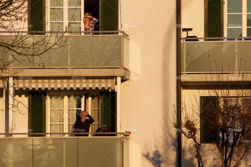 People Enjoying Sunset View From Balconies