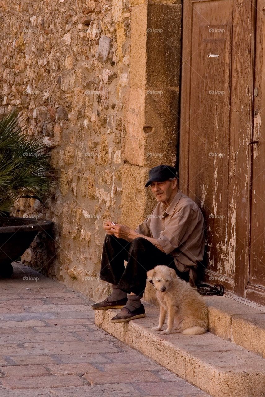 And sitting on a doorstep with his dog