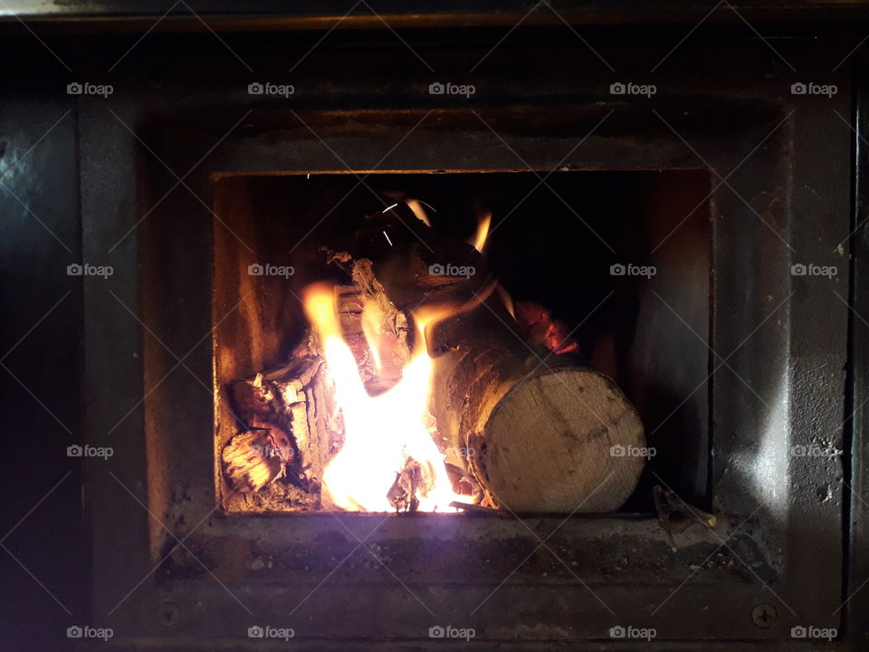 the warm of the fire from the stove
