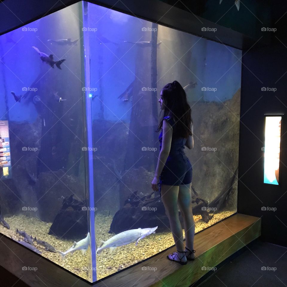Woman standing in aquarium
