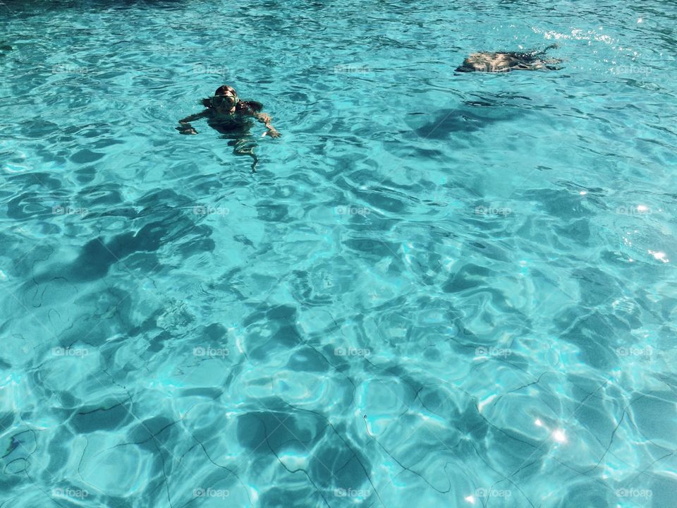 Woman in goggles swimming in the pool