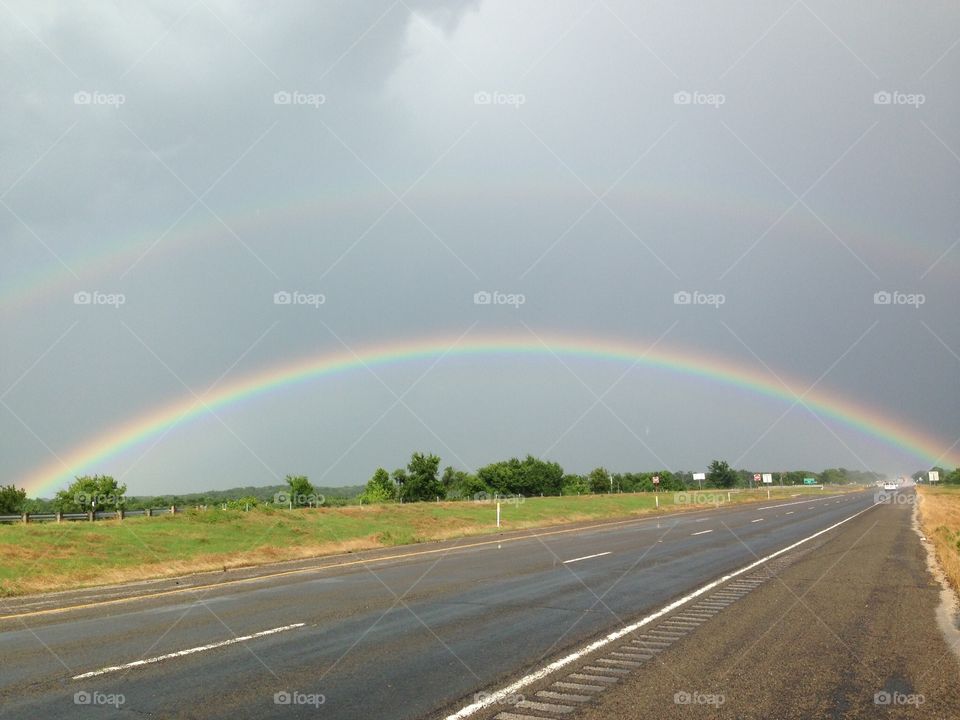 Double rainbow over the road. Nature 