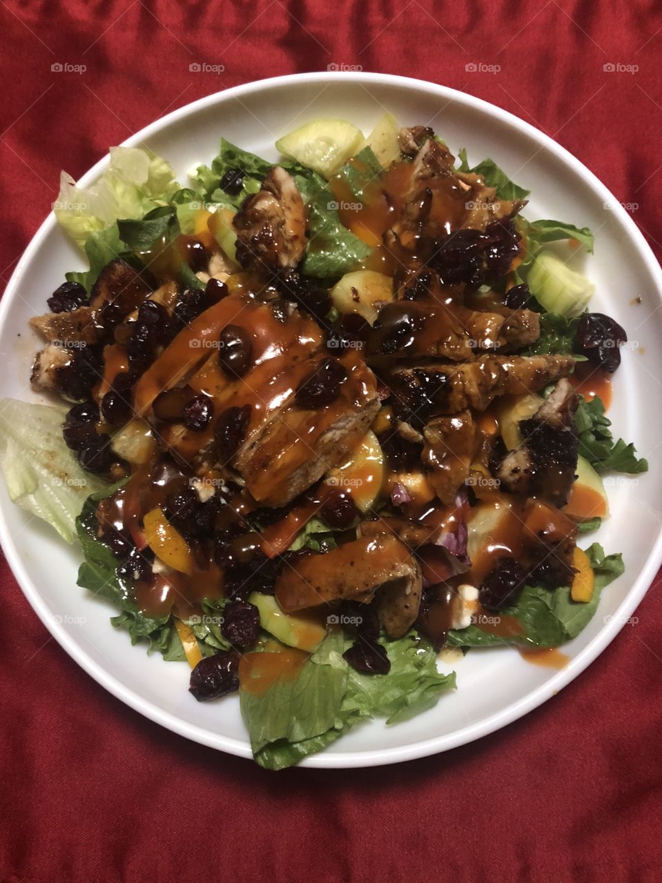 Mixed greens, carrot slivers, cucumbers, sweet peppers (red yellow and orange), feta cheese, cranberries, glazed almonds and grill chicken.