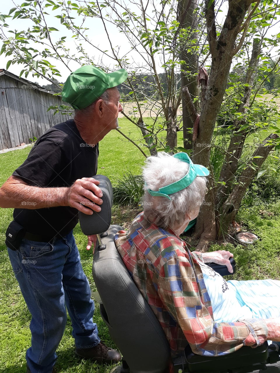 Pop and mom looking over their yard