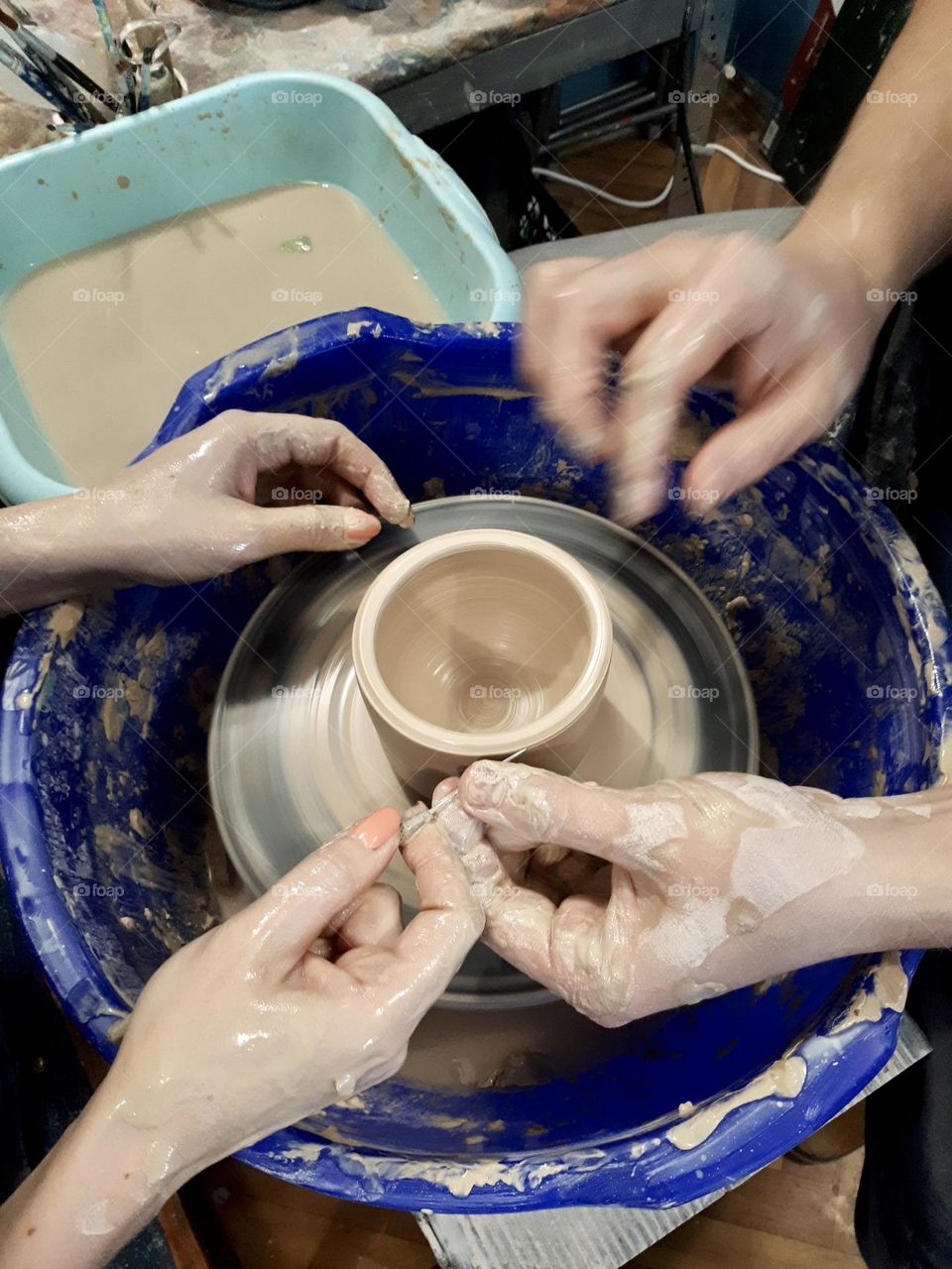 Pottery work shop. Hands doing cup from the clay 