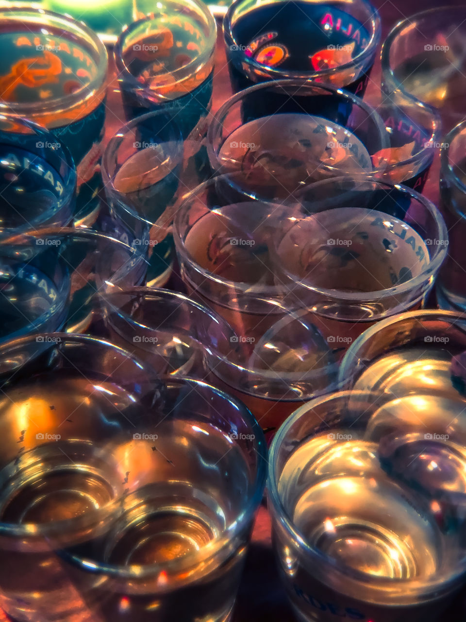 Seeing double in a drunken sense, a view of many drinks glasses taken through a kaleidoscopic lens giving a double vision appearance 