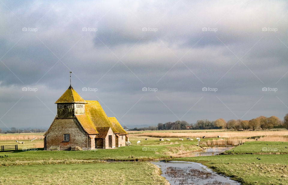 Historical Church built in the middle of marshland and sheep filled fields