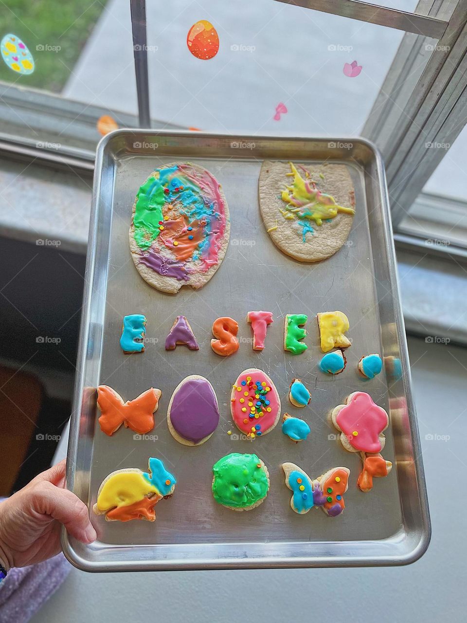 Easter sugar cookies on a tray, making sugar cookies for the holidays, finished Easter sugar cookies ready to eat, homemade Easter sugar cookies, brightly frosted sugar cookies 