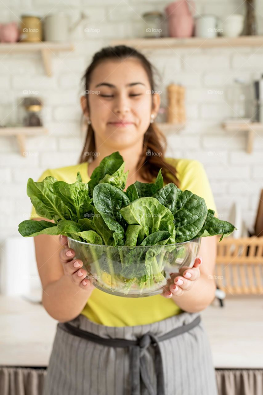 woman holding spinach