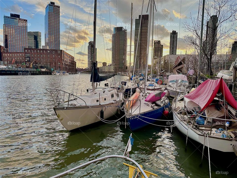 This is “Newtown Creek” by the “Pulaski Bridge” in LIC, Queens with all its boats that are moored here. Tonight the “East River” shimmers in bright tones of silver further enhanced by the silver clouds reflecting therein. 2024. Hypnotic Productions