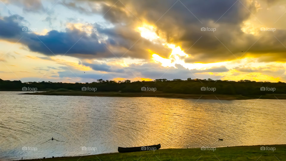 Sunset at a lake with a canoe on the side