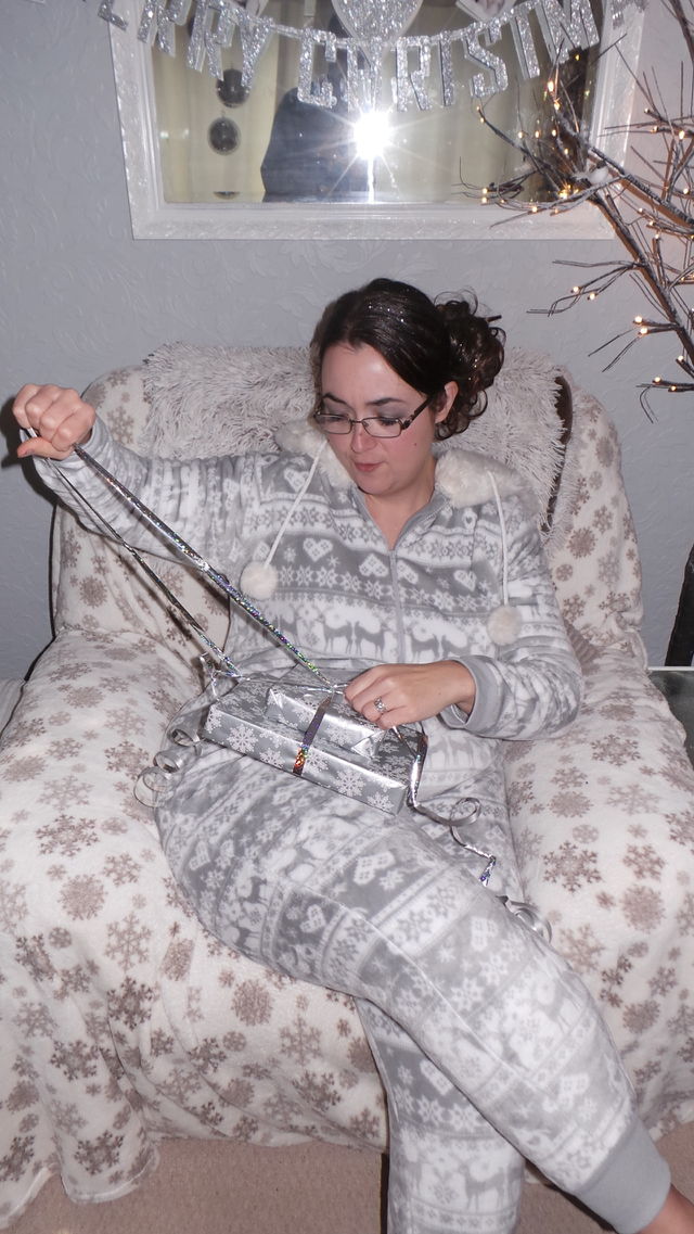 woman on Christmas day opening gifts