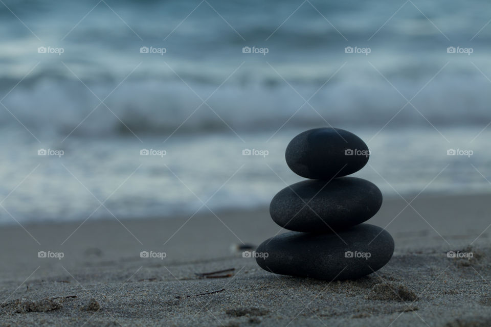 Stack of pebble on sand at the beach
