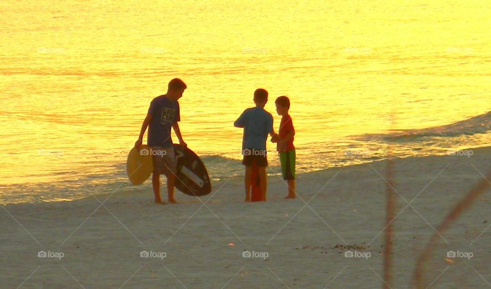 Children's play. Children enjoying the golden hour by the golf of Mexico 