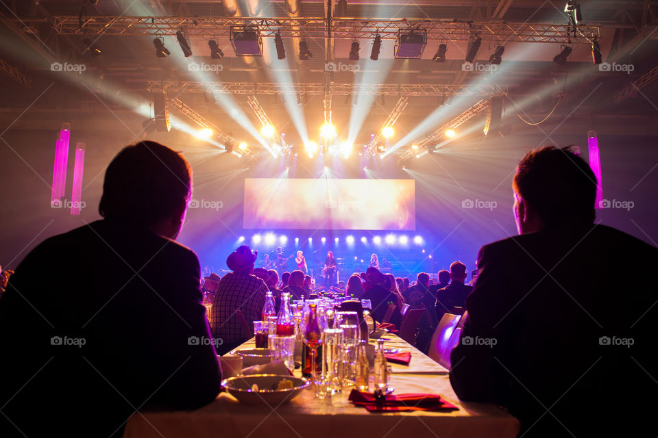 A large corporate event with live performers and various appearances in a large arena.