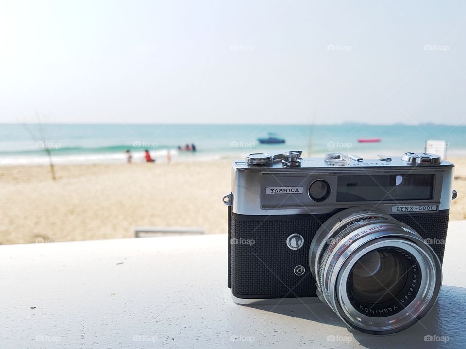 traveler retro vintage film camera on the beach