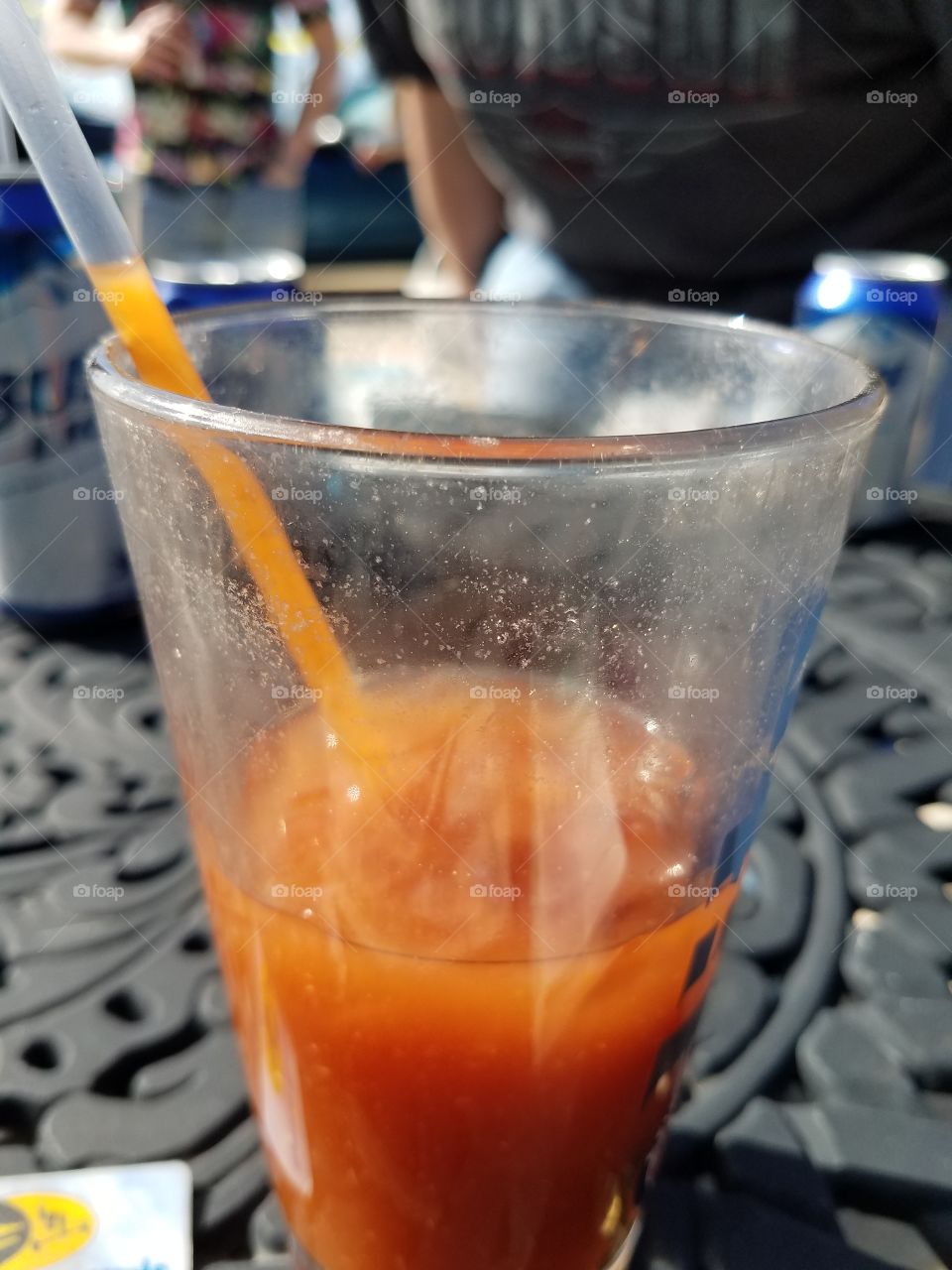 Enjoying a bloody Mary.  fascinated the drink stayed in the straw.