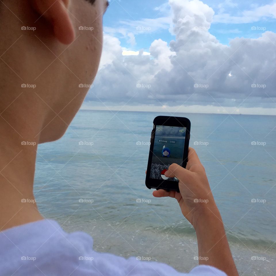Catching Pokemon on the beach